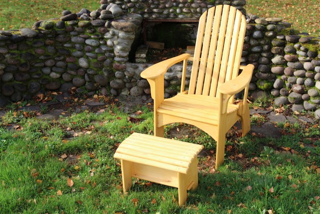 chair and ottoman on grass next to outdoor fireplace
