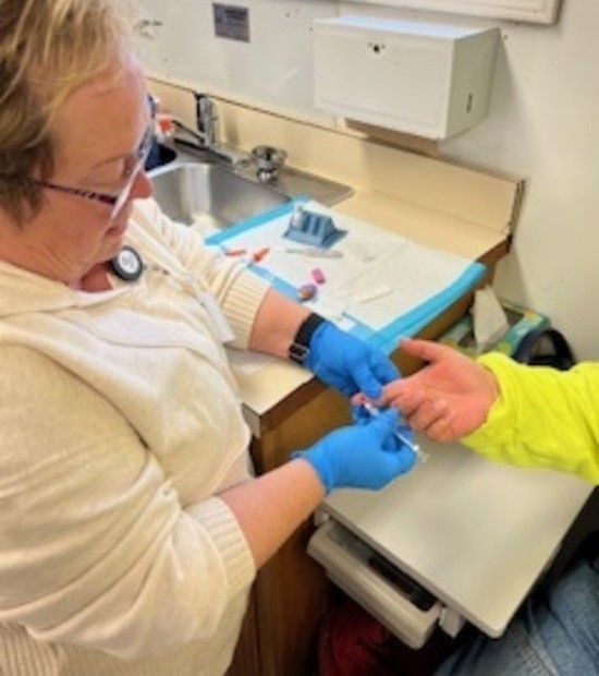 A Lincoln County Public Health staff member administers a syphilis test.