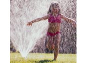 Image of a kid running through sprinkler