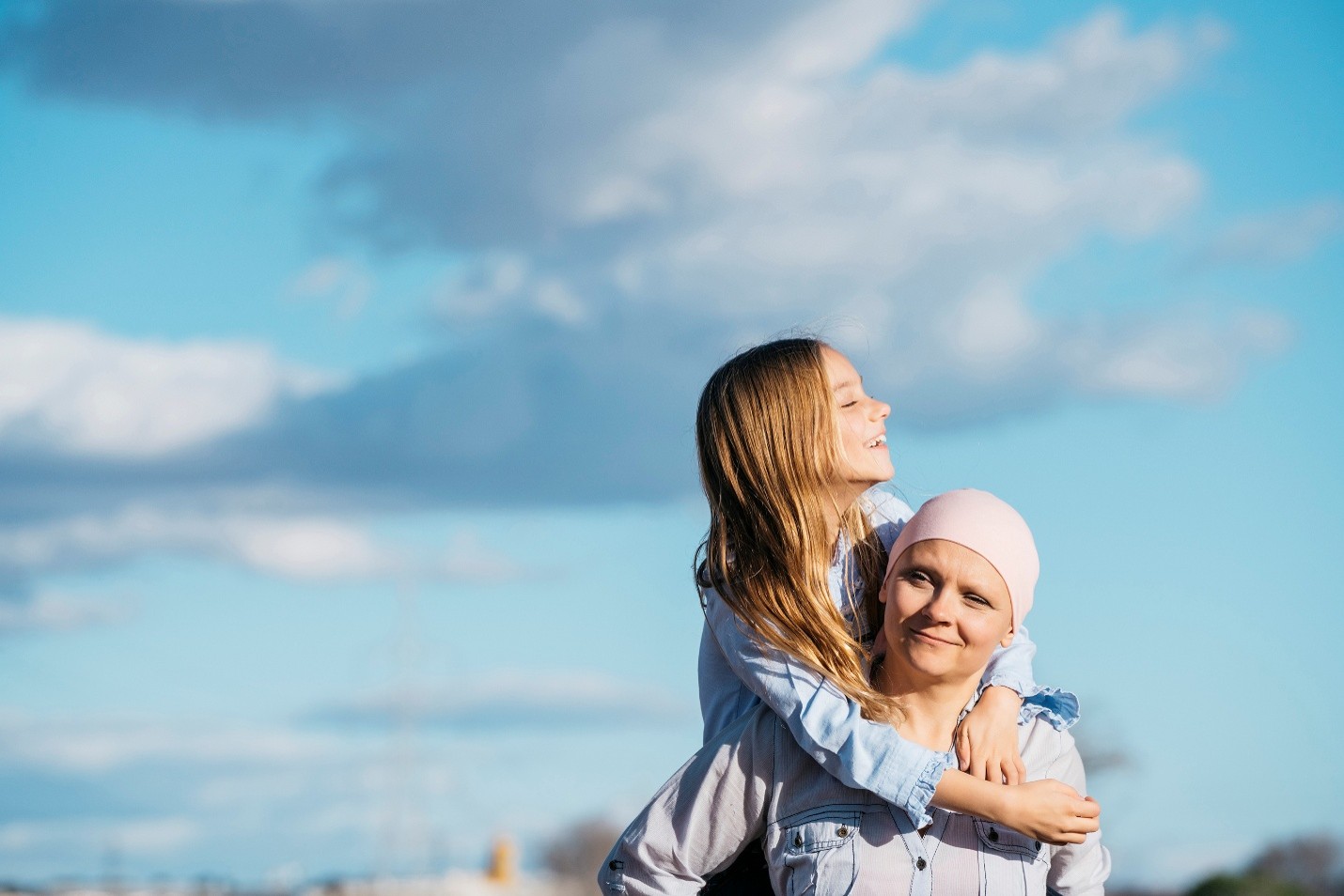 A child riding on the shoulders of an adult.