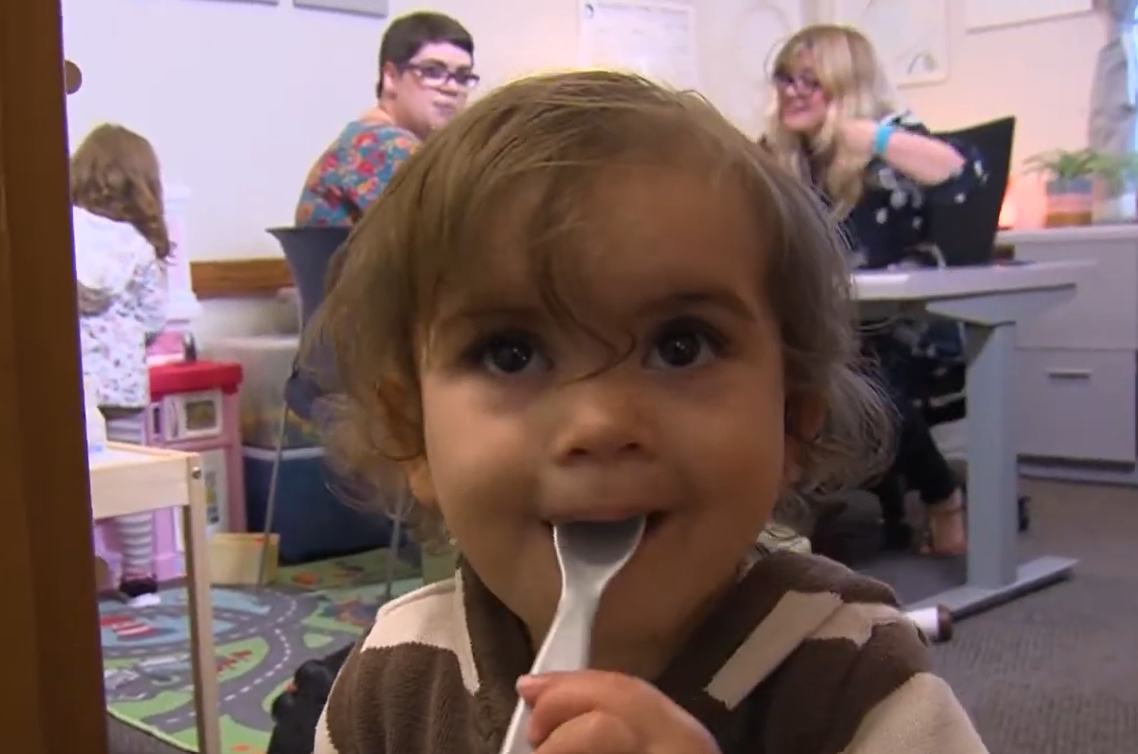 Child with a spoon in their mouth