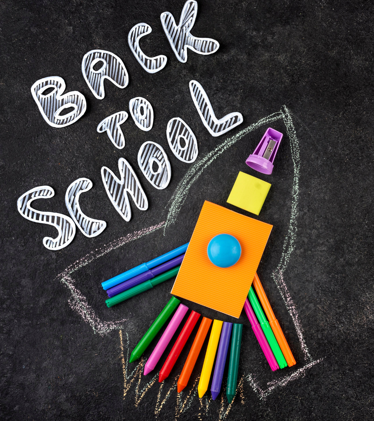 Blackboard background with school supplies in shape of rocket ship. Text: Back to school.