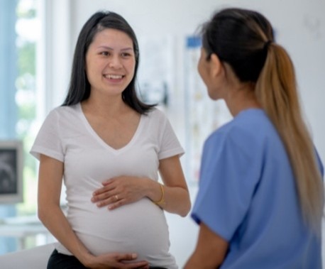 Pregnant lady talking to a medical person