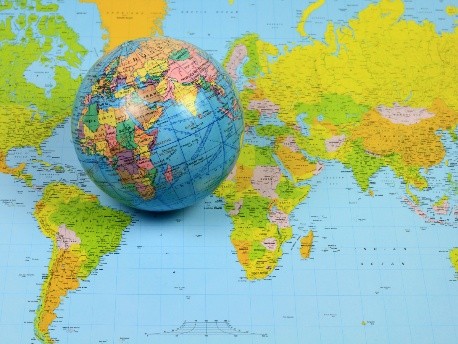 Two women sitting outdoors with beverage mugs