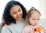 Teenager reading to small child