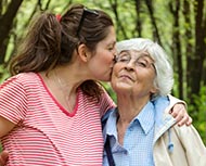 Pregnant woman hugging grandmother