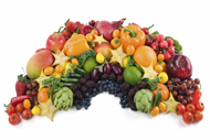A variety of colorful fruits and vegetables arranged in a rainbow shape