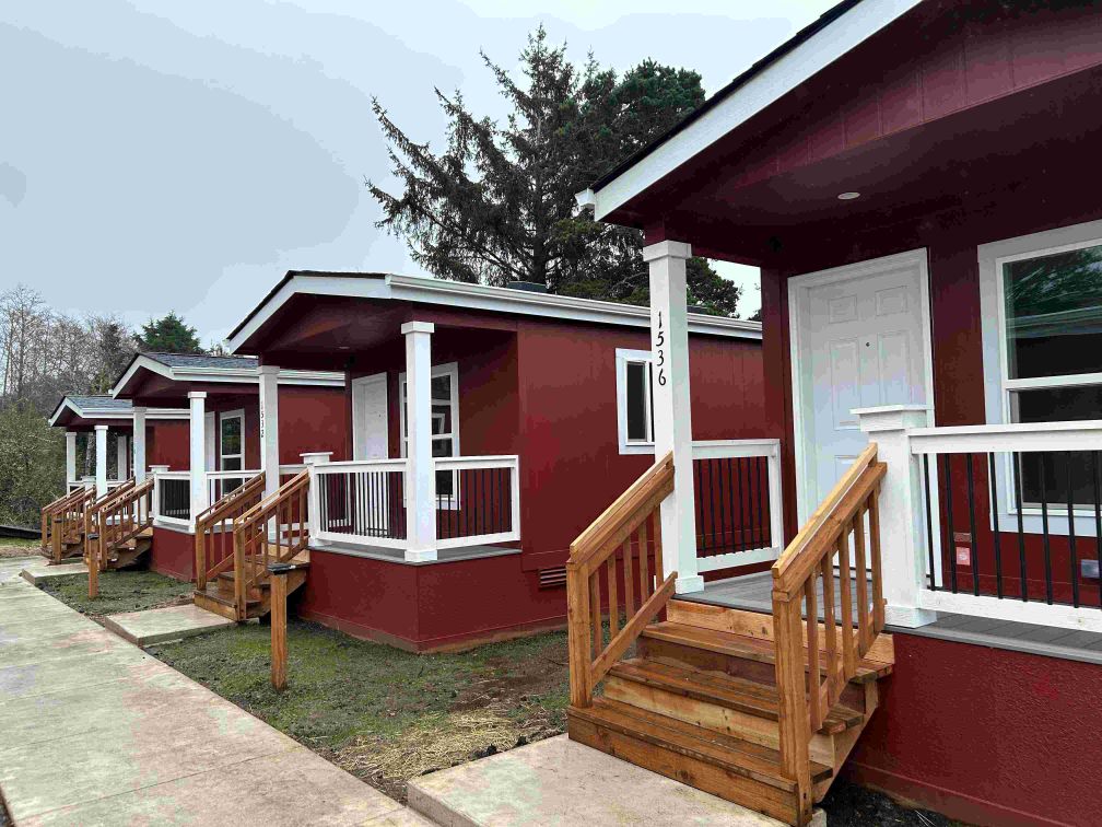 photo of red tiny homes in a row