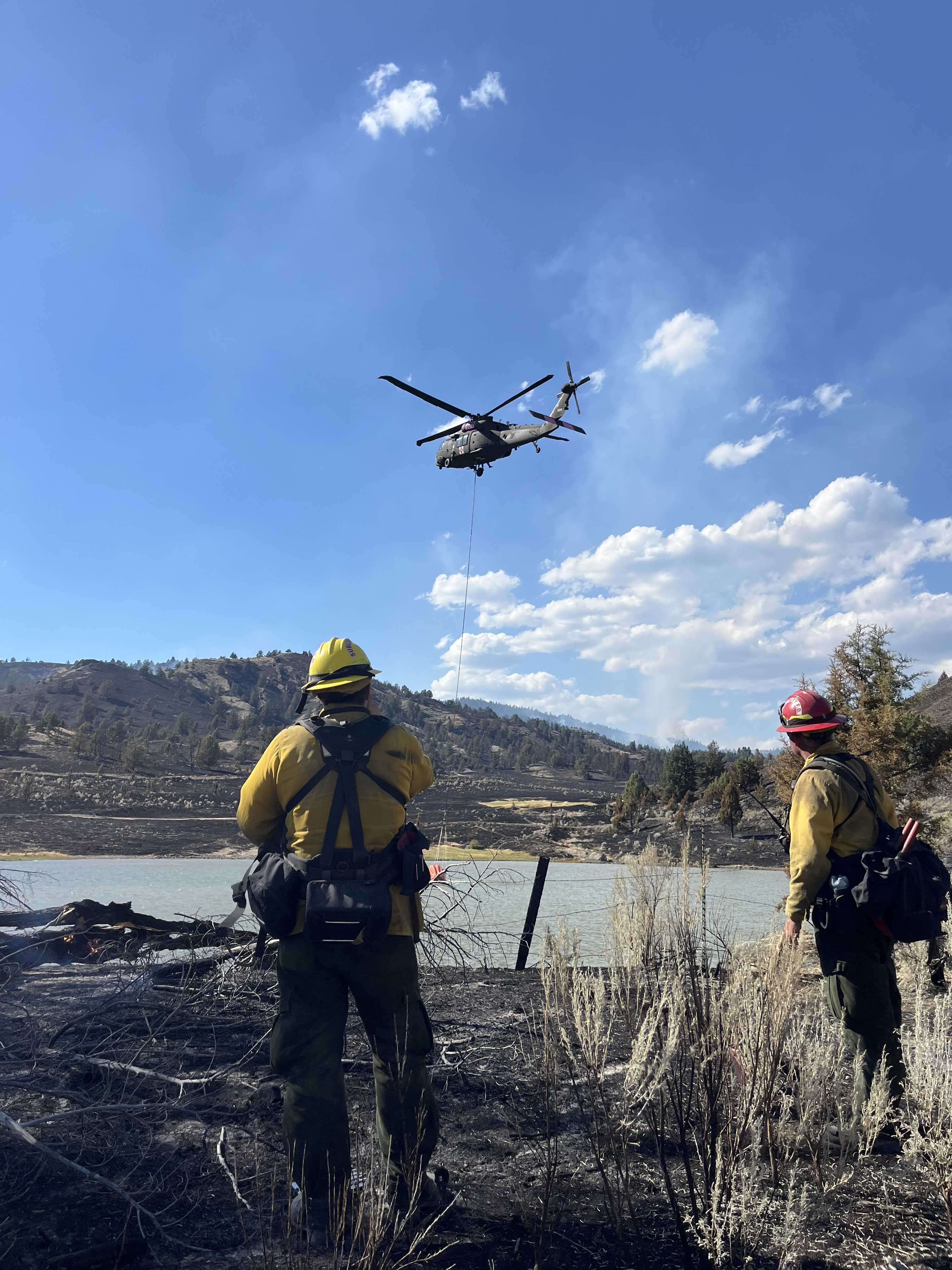 firefighters watching a helicopter