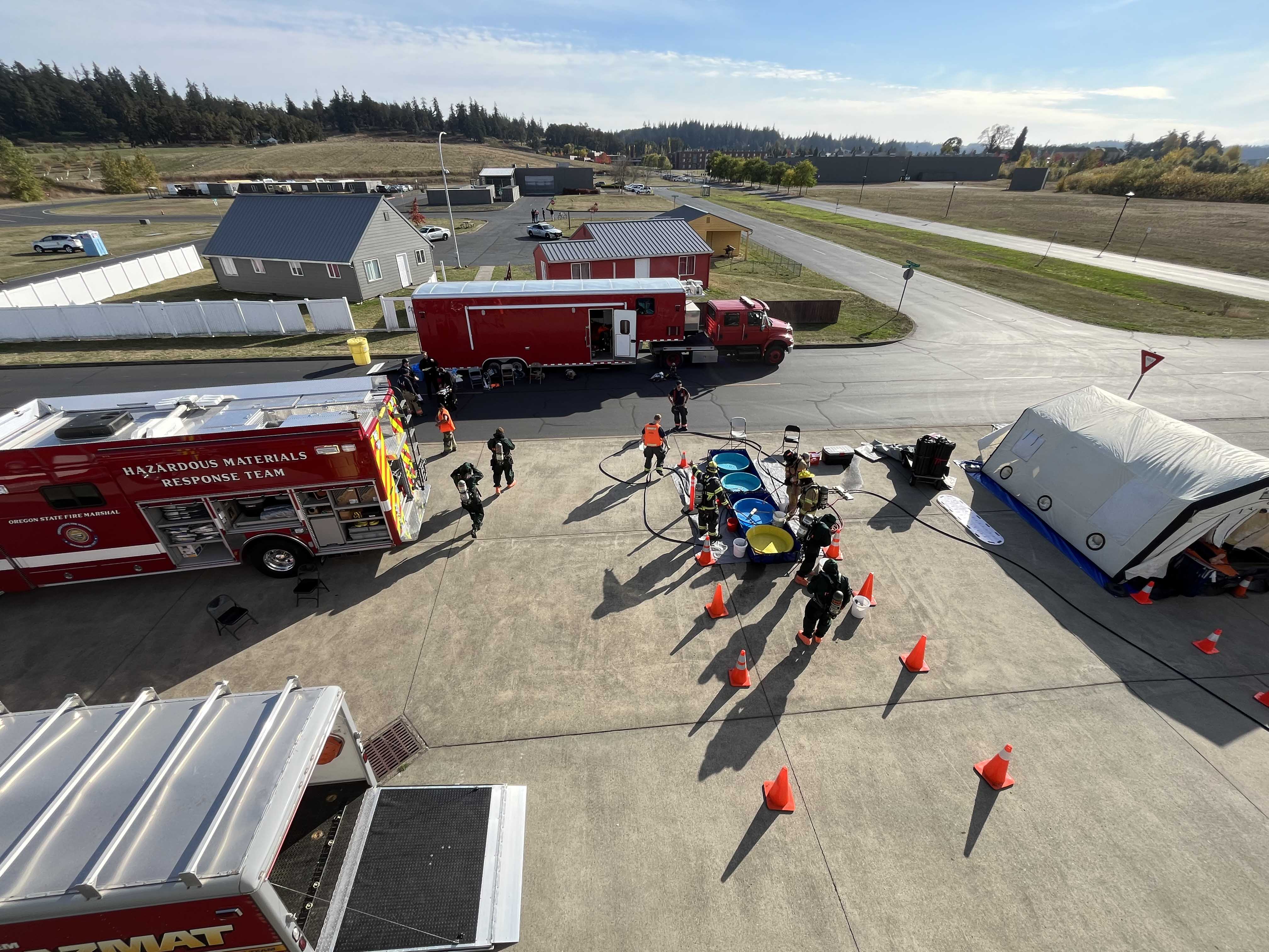 Looking down at a hazmat scene surrounded by fire engines