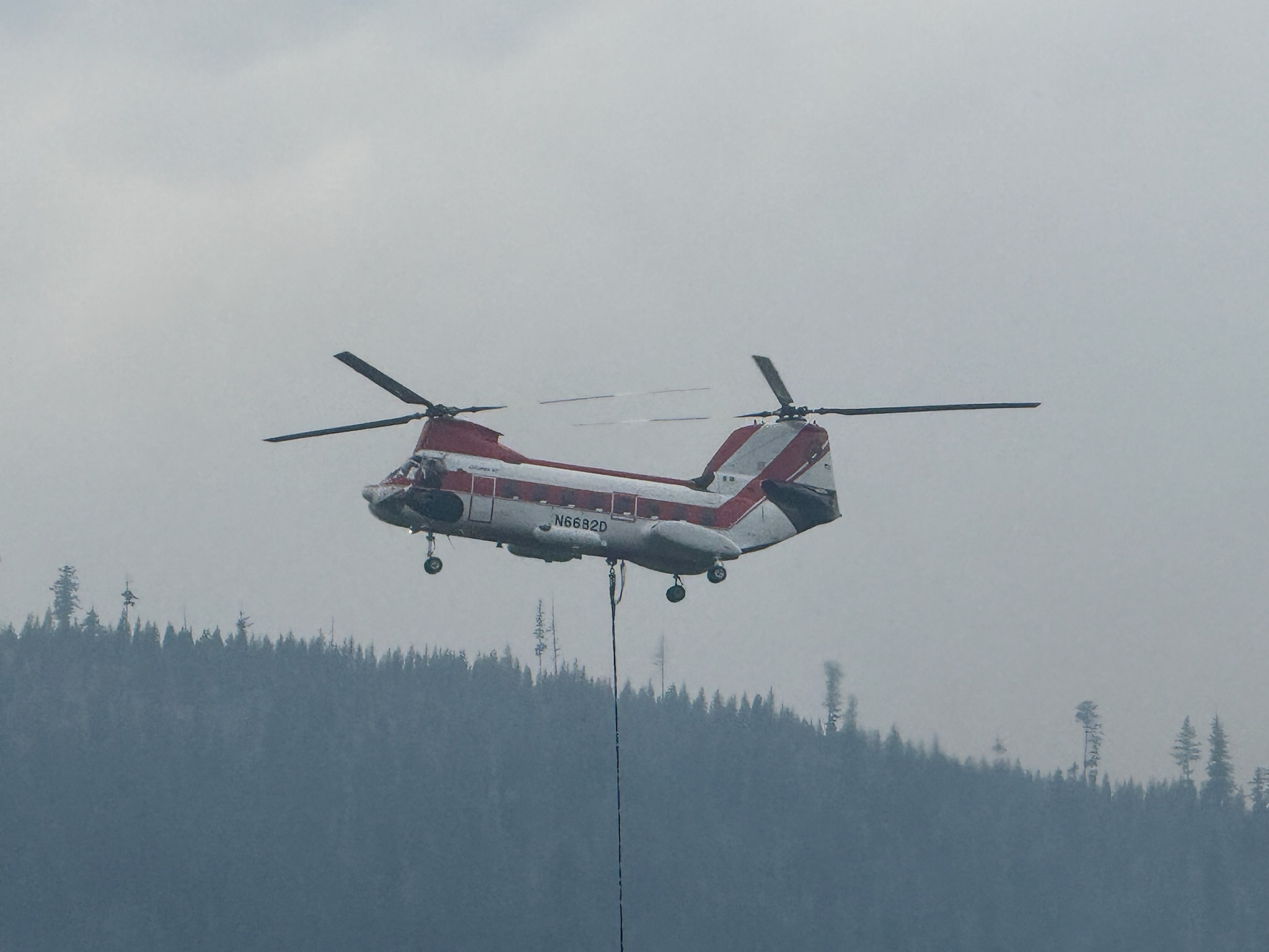 Olive Butte wildfire smoke rising over mountain ridges