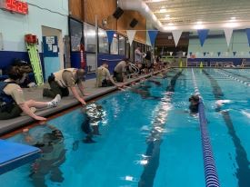 Students learning breathing techniques in a pool