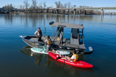 Connect -Marine law enforcement engaging with a kayaker and stand up paddleboarder