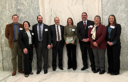 Partners in the Klamath Siskiyou Oak Network stand with award in the US Capitol