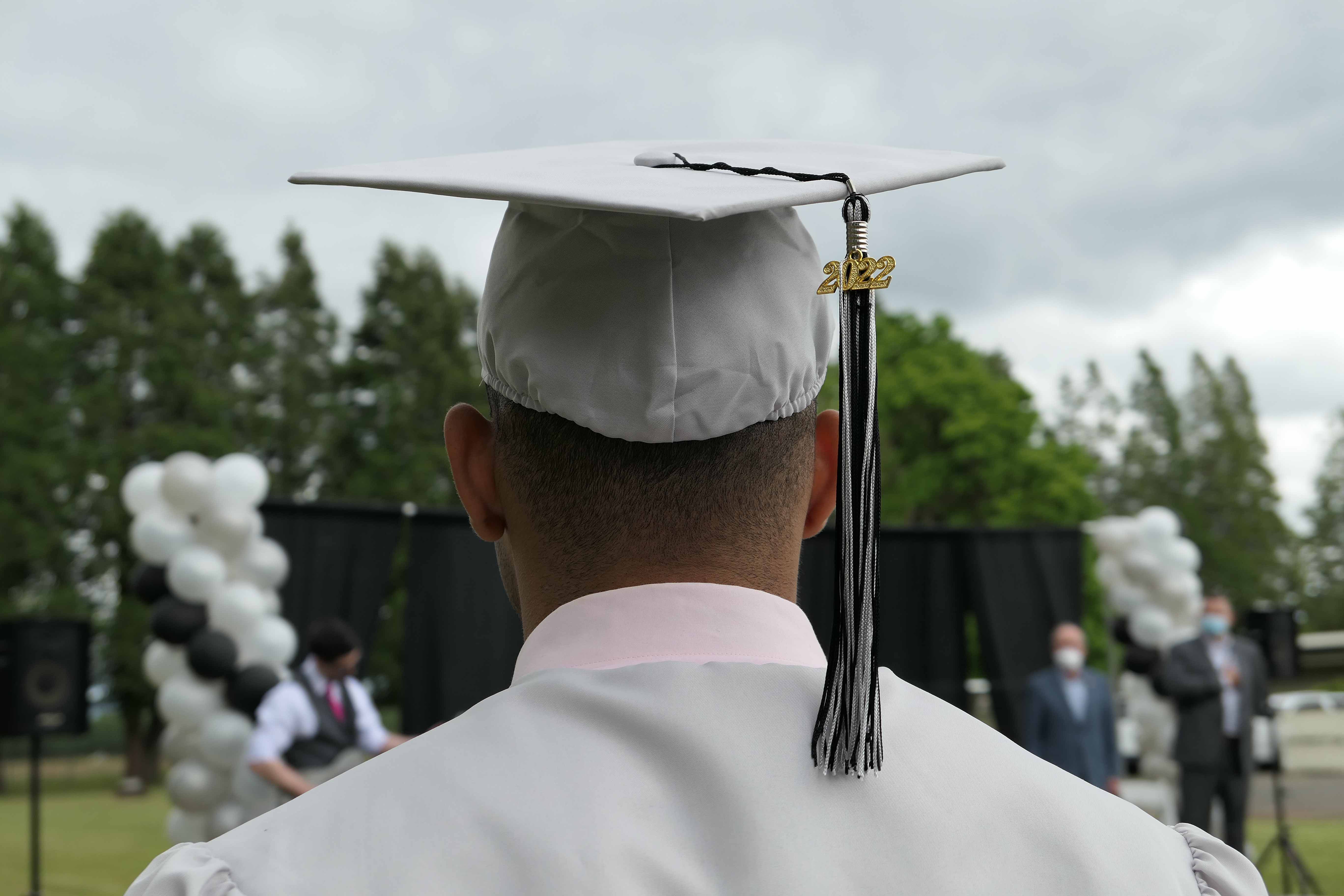Graduate wearing a cap and tassel, shown from behind