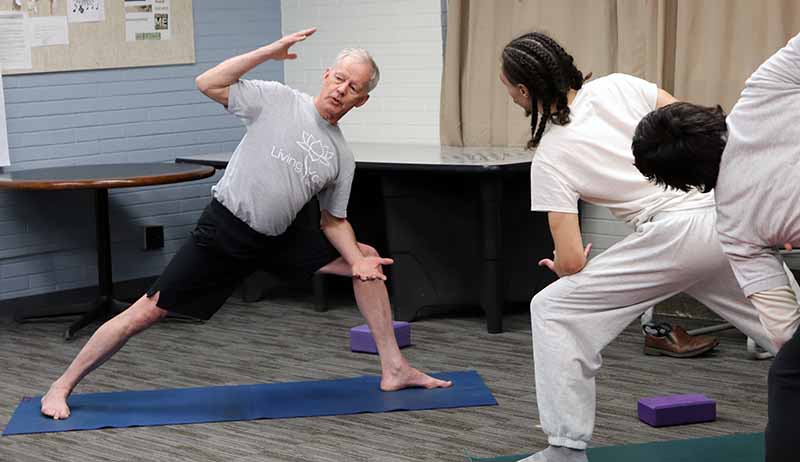 man teaching yoga