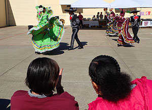 youth watch Latino dancing