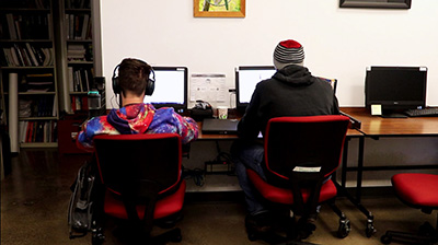 youth sit at desktop computers in computer lab.jpg