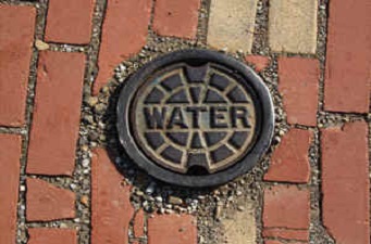 Water main cover that says water