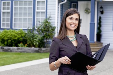 Realtor in front of a house