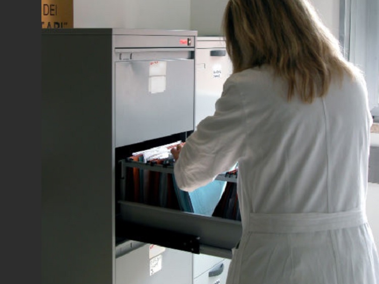 Woman looking through files in a file cabinet