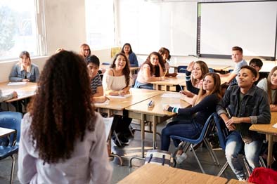 Image of a teacher and students in a classroom