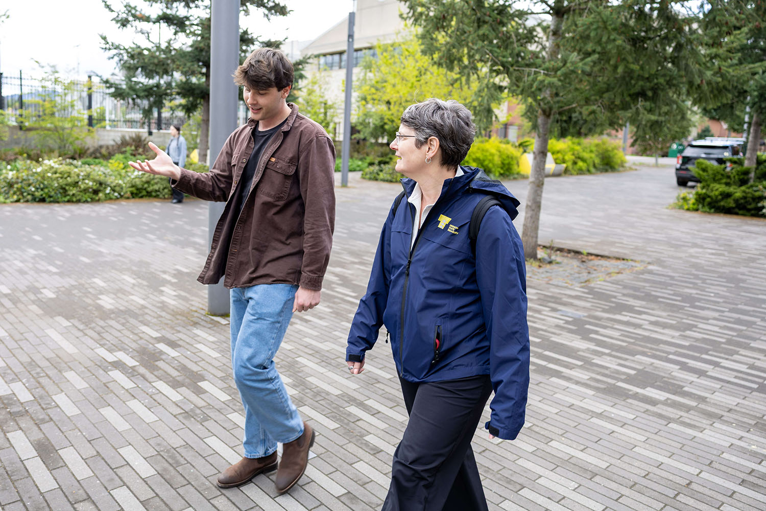 Treasurer Steiner walks through the University of Oregon campus with David Mitrovcan Morgan.