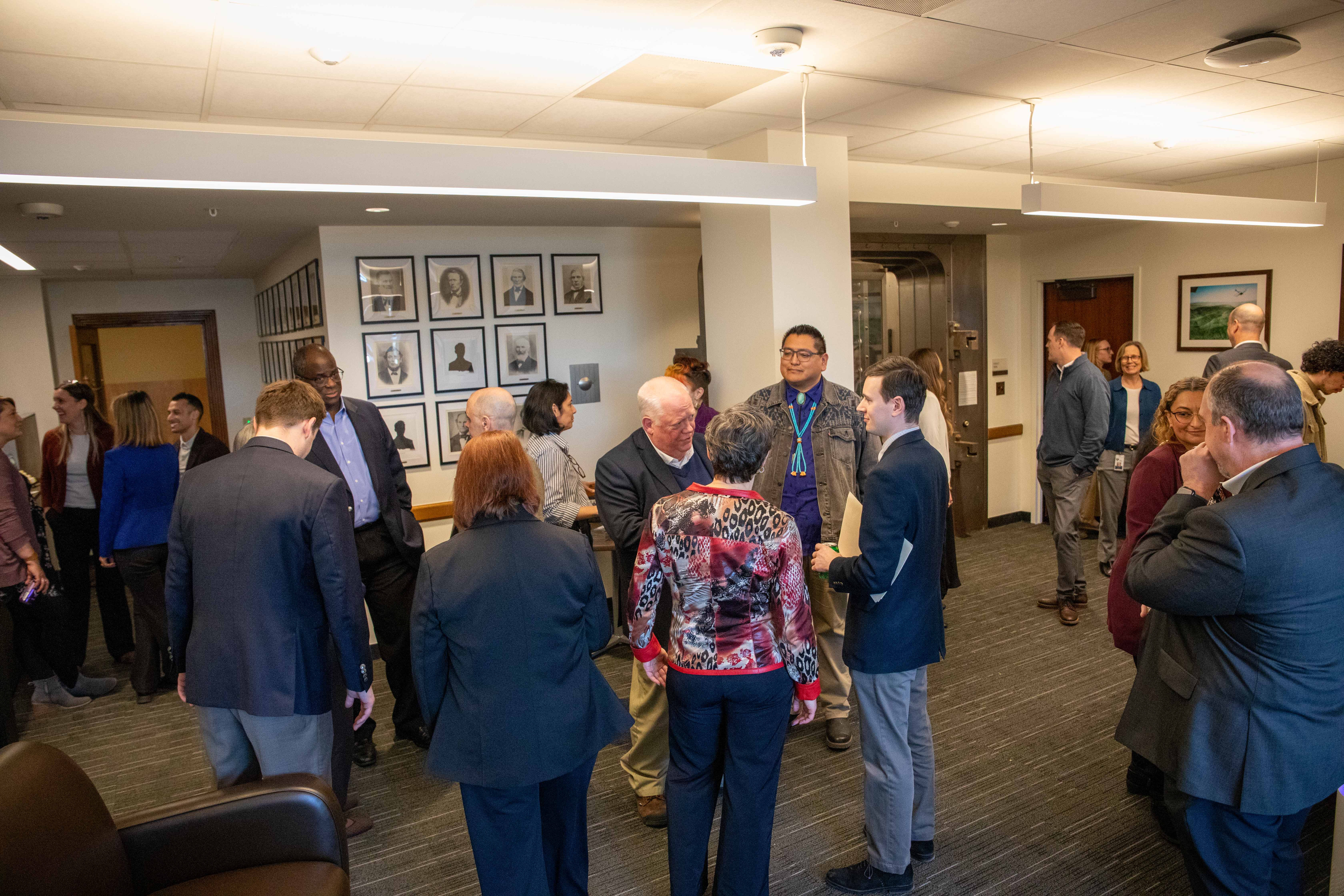 Picture of Treasurer Steiner, others meeting in the main office