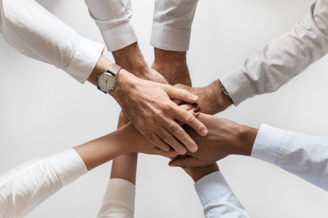 image of lots of hands coming together to represent programs and resources